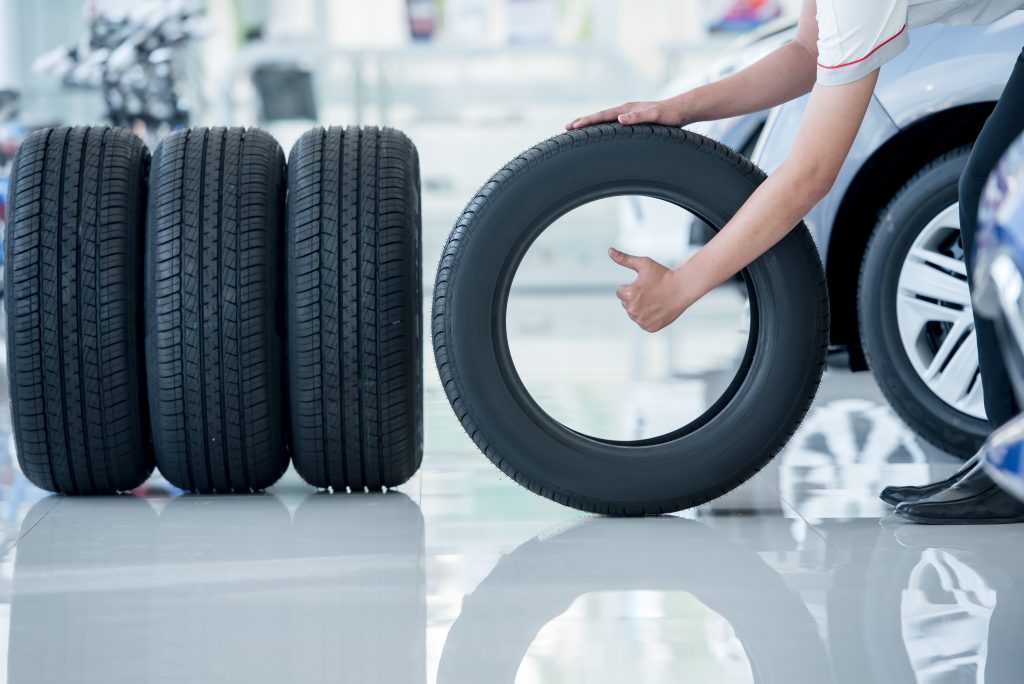 New set of tires being handled in auto service center
