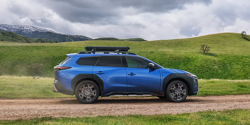 subaru vehicle on a road with greenery  surrounding