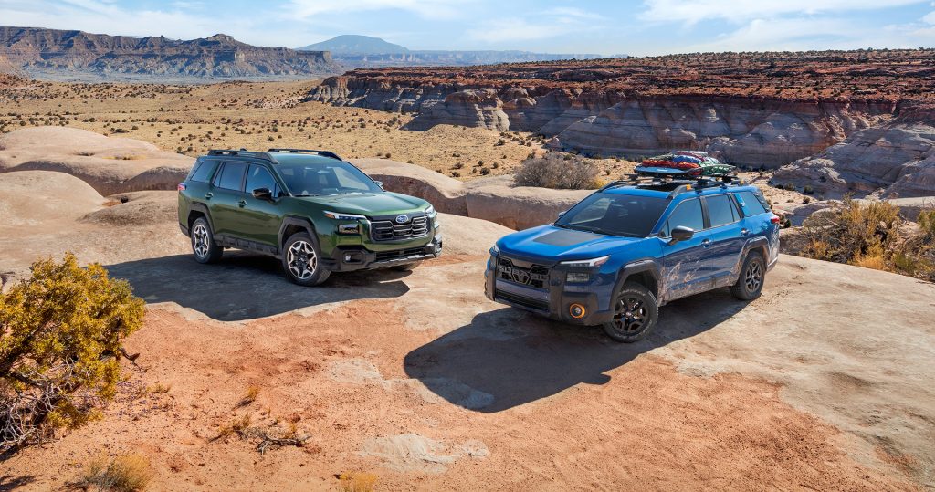Two Subaru SUVs in desert canyon
