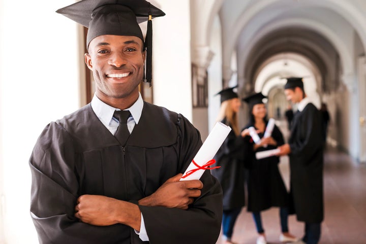 college graduate holding his diploma | DELLA Subaru of Plattsburgh in Plattsburgh NY