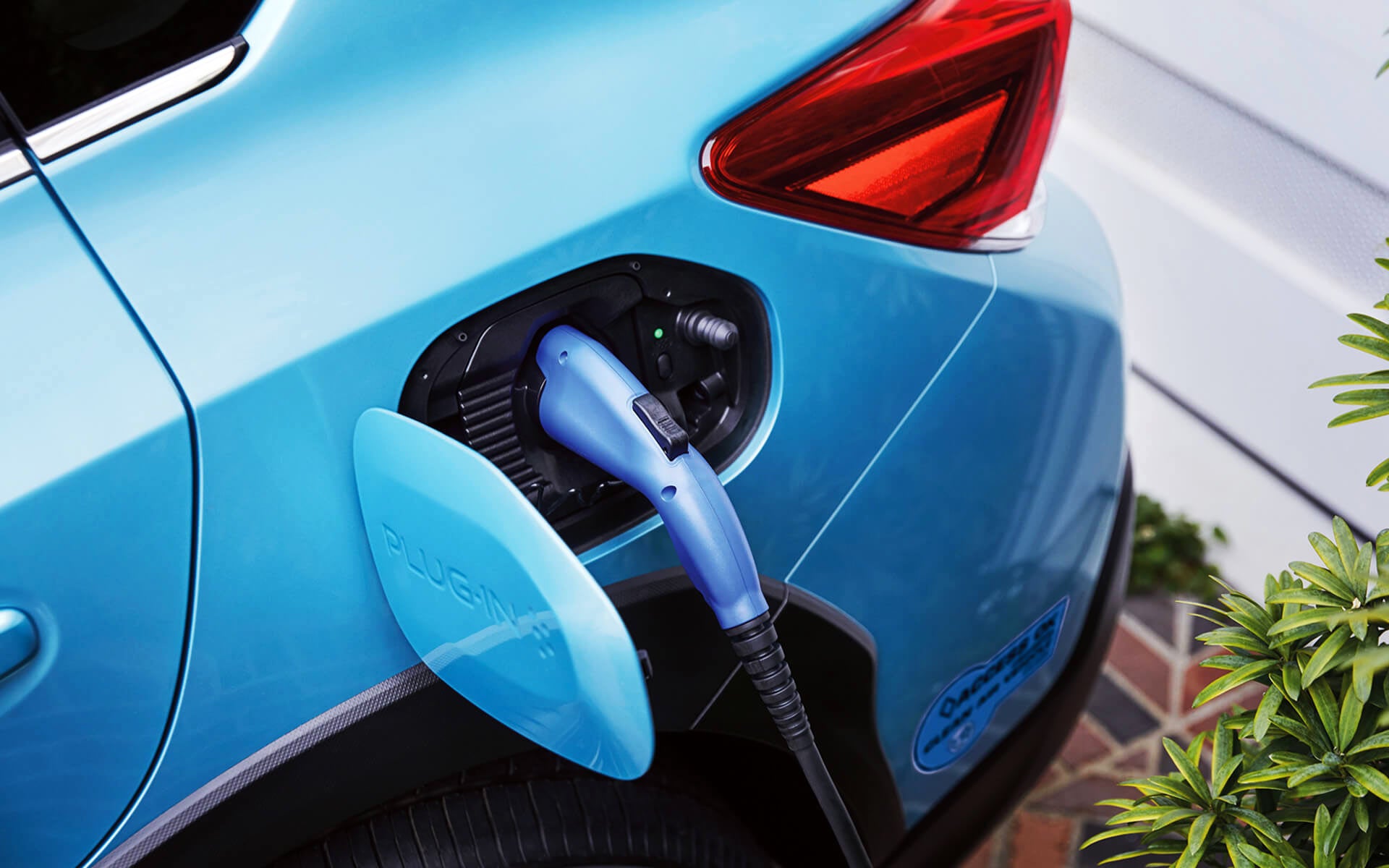 A close-up of the Subaru Crosstrek Hybrid's charging port with charging cable plugged in | DELLA Subaru of Plattsburgh in Plattsburgh NY