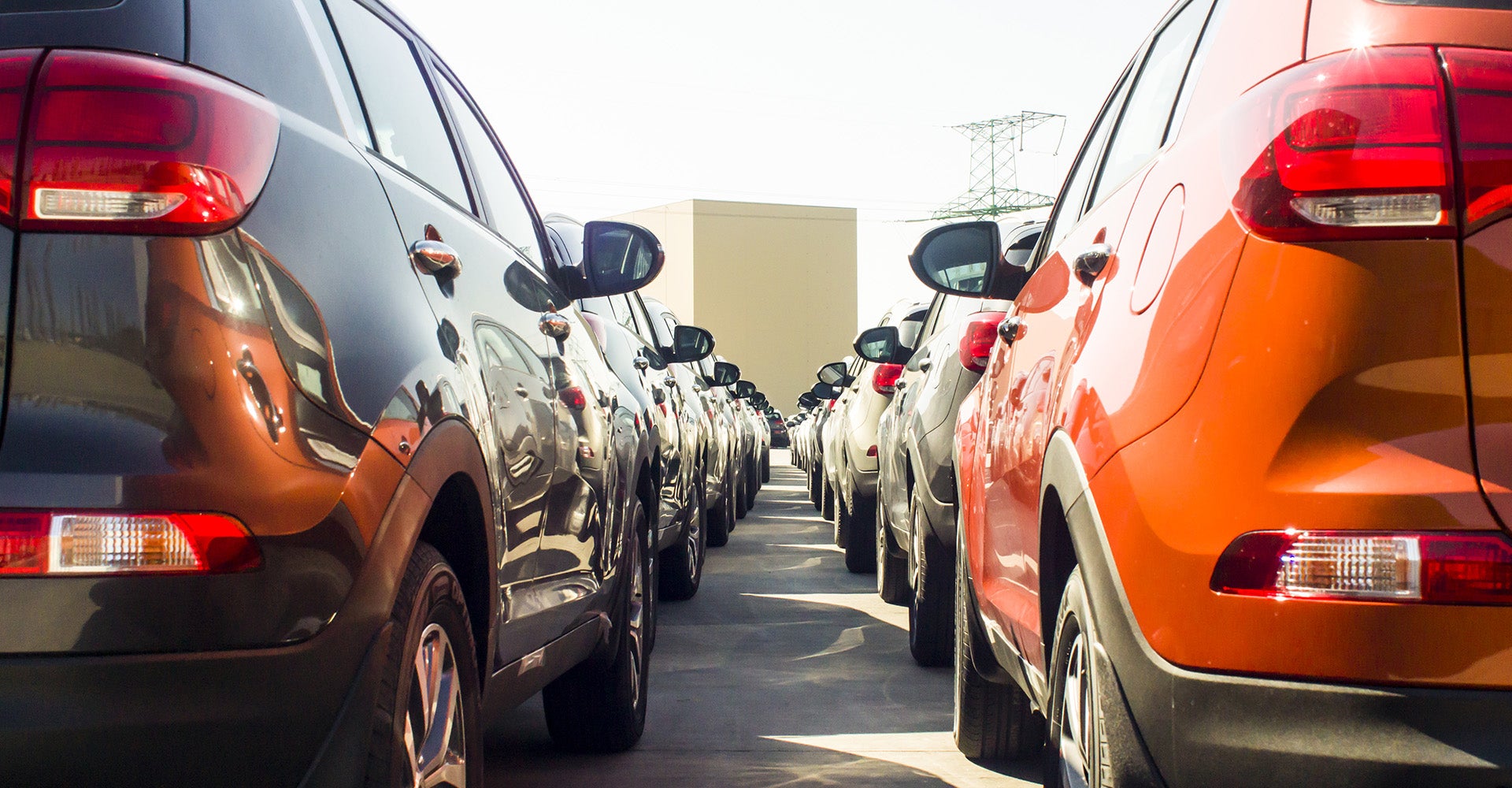 Rows of cars parked at a dealership.
